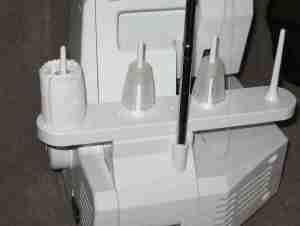 I wrap fabric around the spool holders so the cardboard spools fit snugly.