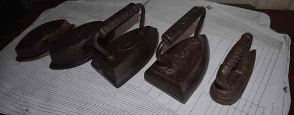 five antique sad irons on pattern